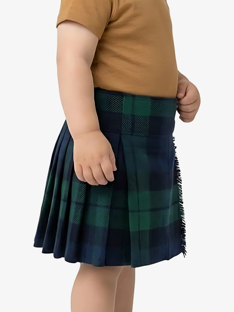 Child wearing a green plaid skirt on a white background