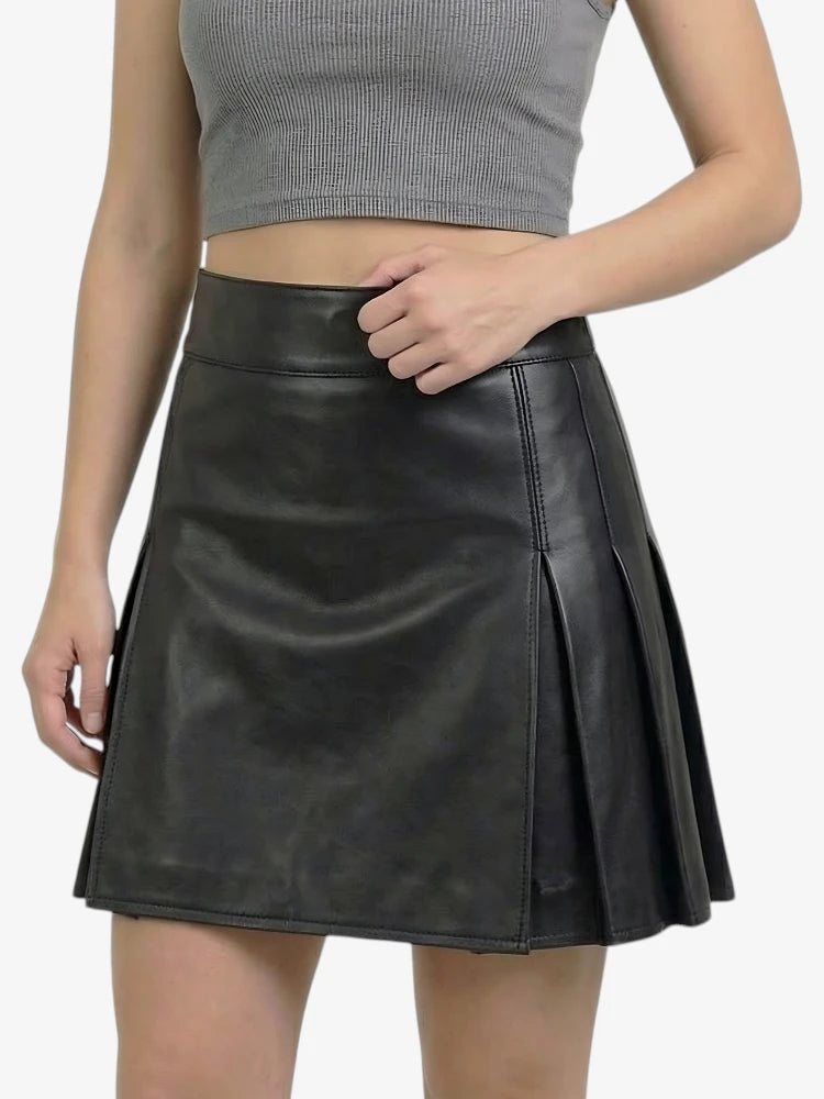 Black leather skirt worn by a person on a white background
