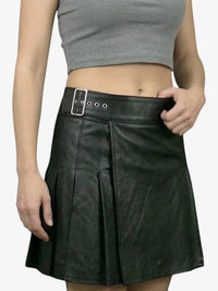 Black leather skirt worn by a person on a plain background