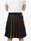 Person wearing a black pleated skirt with colorful stripes on a white background