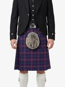 Person wearing a traditional Scottish kilt with a tartan pattern on a white background