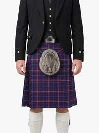 Person wearing a traditional Scottish kilt with a tartan pattern on a white background