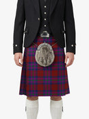 Person wearing a traditional Scottish kilt with a tartan pattern on a white background