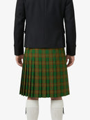 Person wearing a black jacket and green plaid kilt on a white background