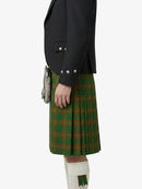 Person wearing a dark jacket and green plaid kilt on a white background