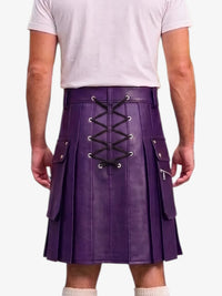 A person shown from the back wearing a purple pleated kilt with black lace-up detailing down the center and side flap pockets, paired with a light gray t-shirt and white socks against a plain white background.