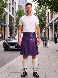 A man stands on a city sidewalk wearing a white crew-neck t-shirt, a pleated purple leather kilt with silver metal grommets, white knee-high socks, and black leather lace-up shoes. The background shows a street with buildings, a black Mercedes-Benz car, and a bicycle.