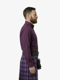 Man wearing a purple shirt and kilt on a white background
