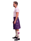 A man shown in profile wearing a purple leather kilt with multiple utility pockets, a white t-shirt, white knee-high socks, and black shoes, set against a plain white background.