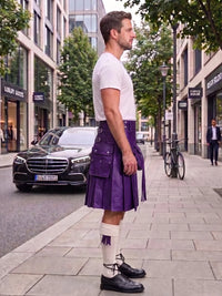 A man wearing a purple leather kilt, white t-shirt, white socks, and black leather shoes stands on a city sidewalk next to a street with a black Mercedes-Benz car and trees.