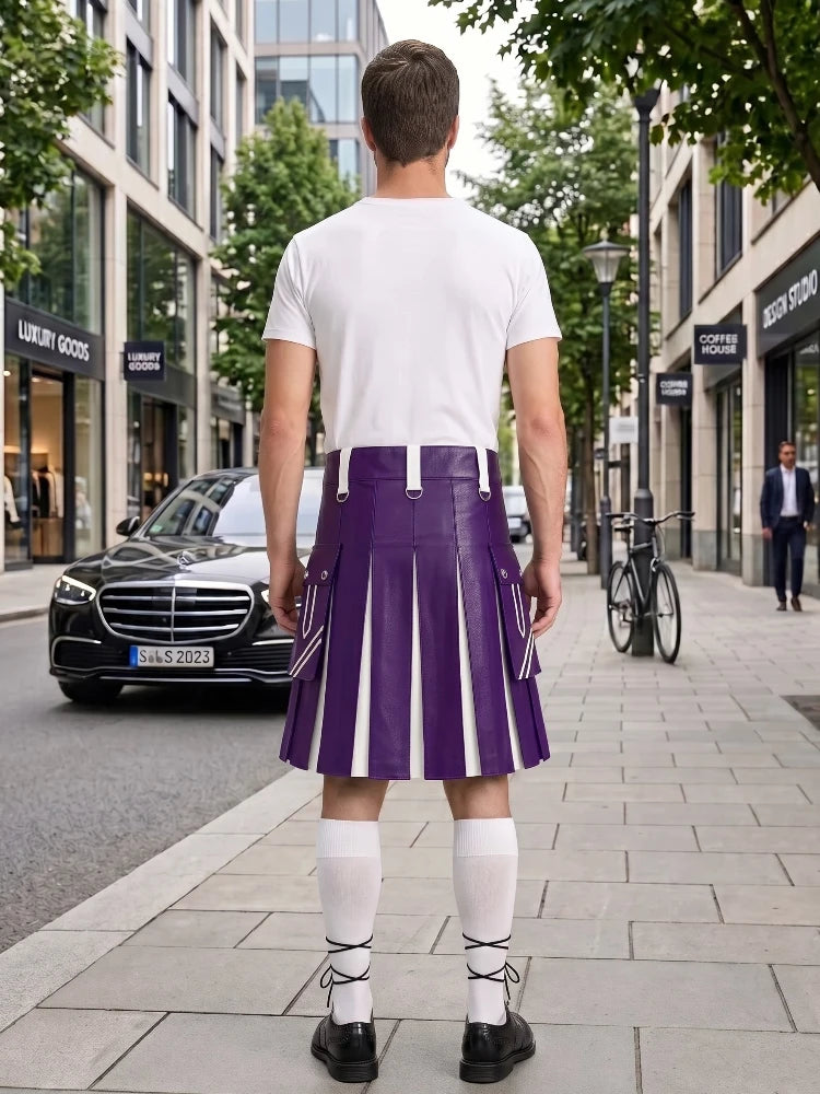 A man standing on a city sidewalk, photographed from behind, wearing a white T-shirt and a purple pleated kilt with white vertical stripe panels, white knee-high socks, and black shoes. Buildings, trees, a black car, and a bicycle are visible in the background.
