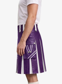 A person wearing a purple and white pleated leather kilt with white drawstrings and silver hardware, paired with a white t-shirt, shown from the side against a light gray background.