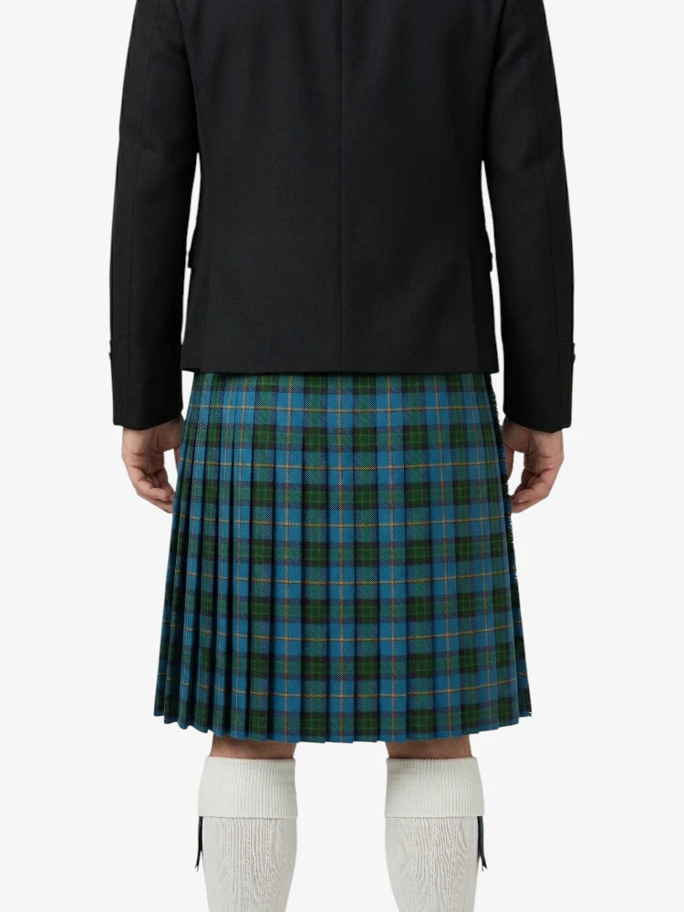 Person wearing a black jacket and blue plaid kilt on a white background