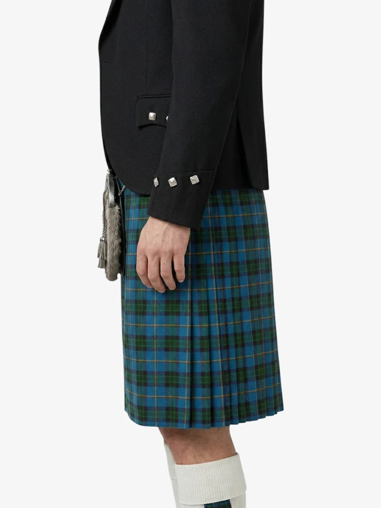 Person wearing a black jacket and blue plaid kilt on a white background