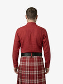 Man wearing a red shirt and plaid kilt on a white background