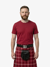 Man wearing a red t-shirt and red plaid kilt on a white background