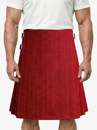 Red herringbone patterned kilt worn by a person on a white background