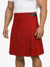 Red patterned kilt worn by a person on a white background