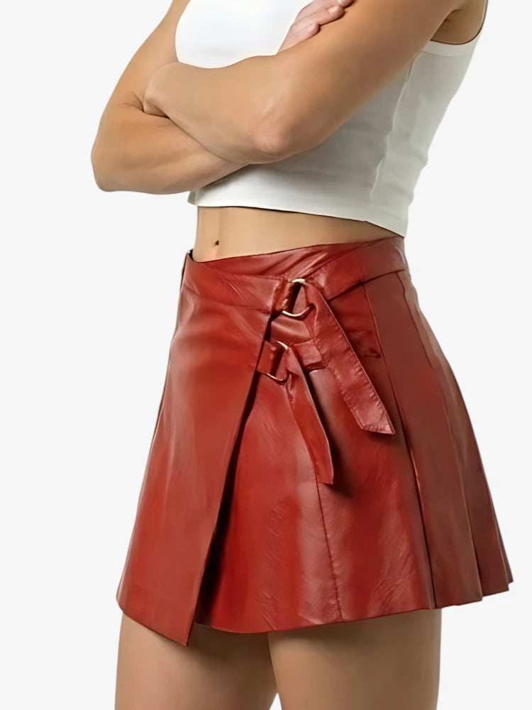 Red leather skirt with a tie waist worn by a person on a white background