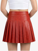 Red pleated skirt worn by a person on a white background