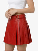 Red leather skirt worn by a person on a white background