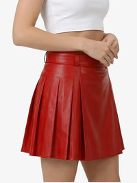 Red pleated skirt worn by a person on a white background