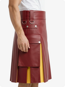 Maroon leather skirt with yellow panel worn by a person on a white background