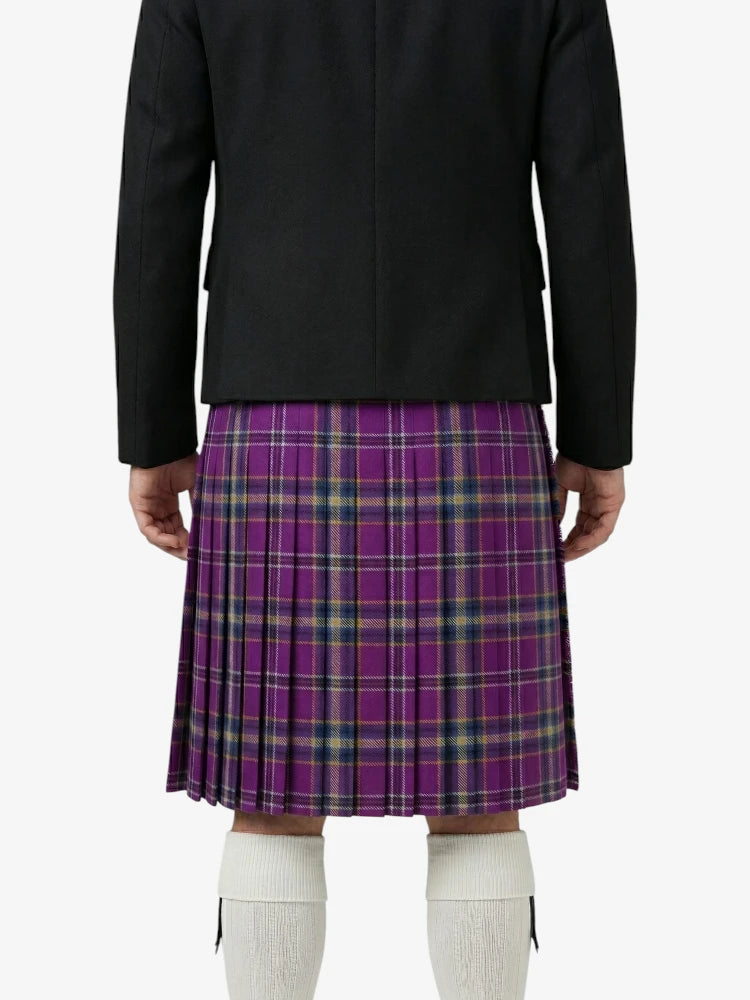 Person wearing a black jacket and purple plaid skirt on a white background