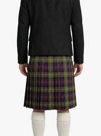 Person wearing a black jacket and green plaid Kilt on a white background