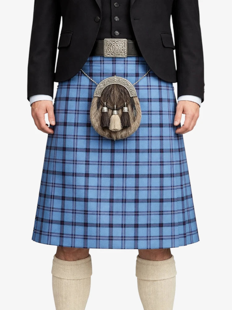 Person wearing a blue plaid kilt with a black jacket and white shirt on a white background