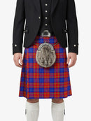 Person wearing a black jacket, red and blue plaid kilt, and white knee-high socks on a white background