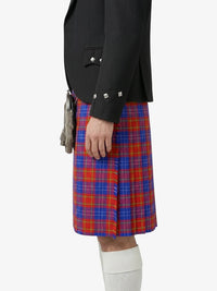 Person wearing a black jacket and red and blue plaid kilt on a white background