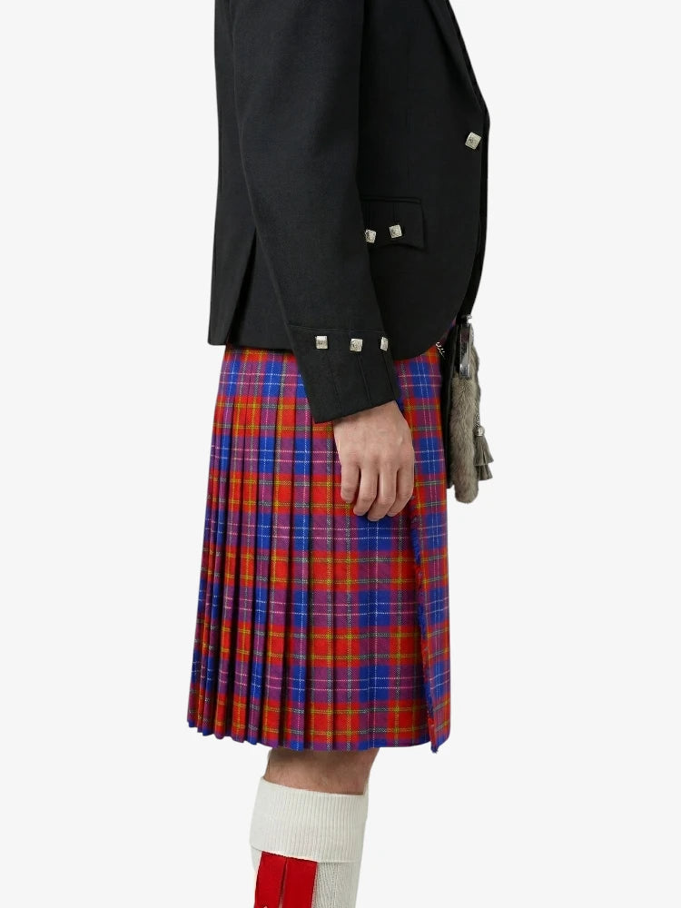 Person wearing a black jacket and red plaid kilt on a white background