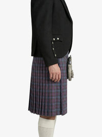 Person wearing a black blazer and plaid kilt on a white background