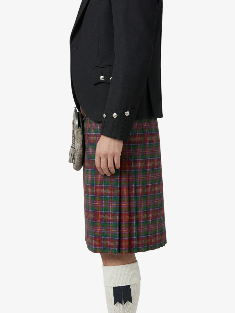 Person wearing a black blazer and red plaid kilt on a white background