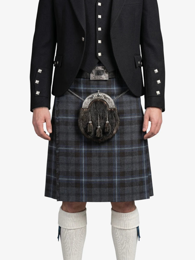 Person wearing a traditional Scottish kilt with a sporran on a white background