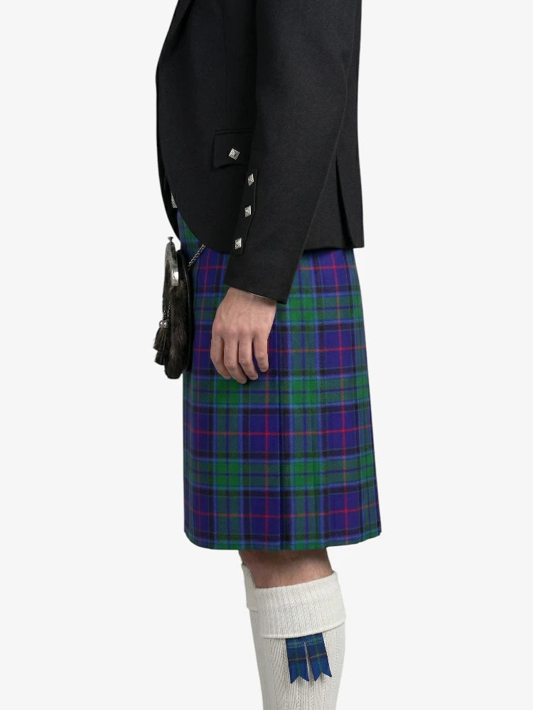 Person wearing a black jacket and a blue plaid kilt on a white background