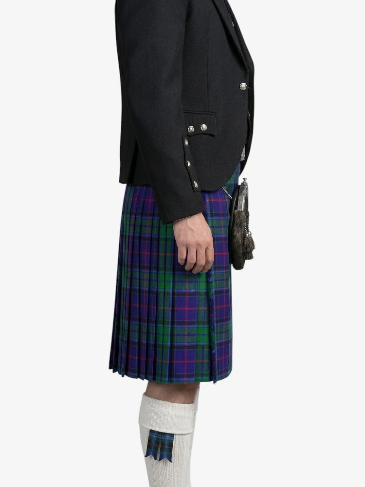 Person wearing a black blazer and a plaid kilt on a white background