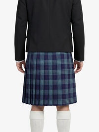 Person wearing a black jacket and plaid kilt on a white background