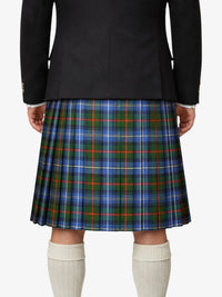 Person wearing a black jacket and plaid kilt on a white background