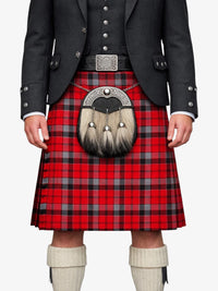 Person wearing a red tartan kilt with a black jacket and white knee-high socks on a white background