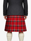 Person wearing a black coat and red plaid kilt on a white background