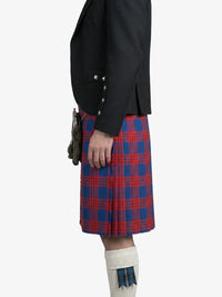 Person wearing a black jacket and red and blue plaid kilt on a white background
