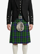 Person wearing a traditional Scottish kilt with a tartan pattern on a white background