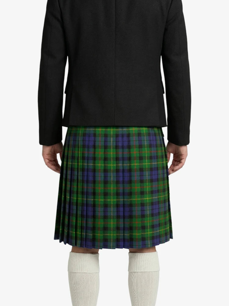 Person wearing a black jacket and green plaid kilt on a white background
