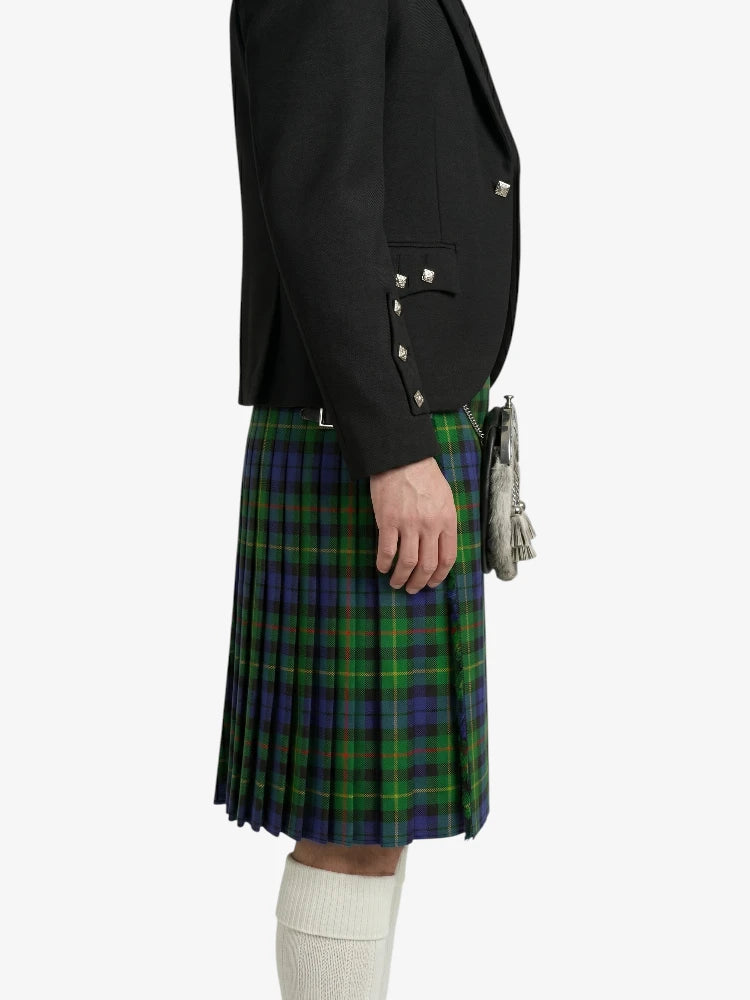 Person wearing a black blazer and green plaid kilt on a white background