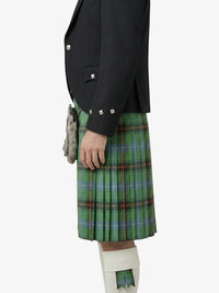 Person wearing a black jacket and green plaid kilt on a white background