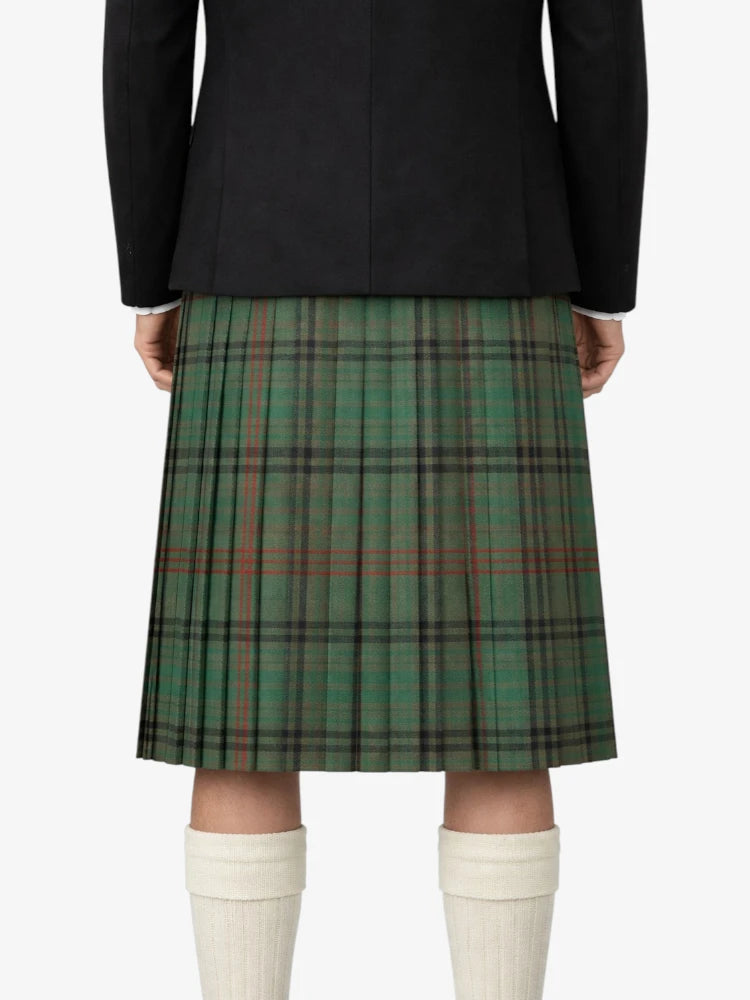 Green plaid kilt worn with a black jacket on a white background