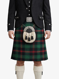 Person wearing a traditional Scottish kilt with a tartan pattern on a white background