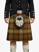 Person wearing a traditional Scottish kilt with a tartan pattern on a white background
